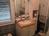 a bathroom with a sink, toilet, and shower in it