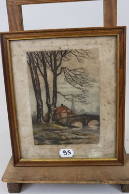 une image représentant une photo d'un tableau posé sur un chevalet en bois