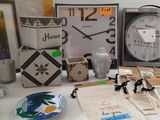 many items on a table with a clock in the background