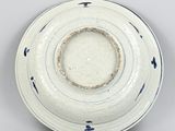 an image of a white and blue plate on a gray surface