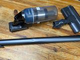 a vacuum that is sitting on a table next to a pen