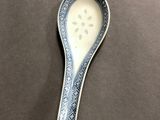 a close up of a spoon with a spoon handle on a table