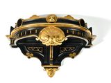 a black and gold clock on a white wall