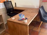 a desk with two chairs and a computer on it