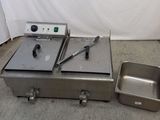 a silver box and a metal pan on the floor