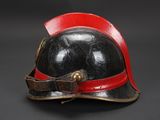 an old helmet with a red band on a black background