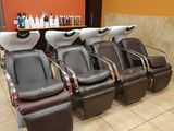 a row of chairs in a salon waiting for people to get their hair done