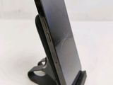 a cell phone that is on a stand on a table
