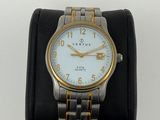 an image of a silver and gold wrist watch on a black watch band