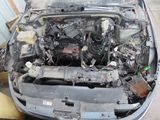a car that has a broken engine in the back of it