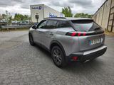 the rear end of a silver suv parked in a parking lot