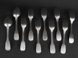 six forks and six spoons arranged in a row on a black surface