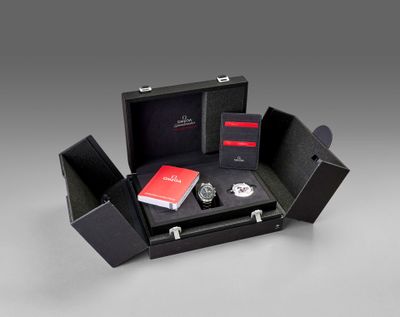 an image of a black box with a watch and other items in it
