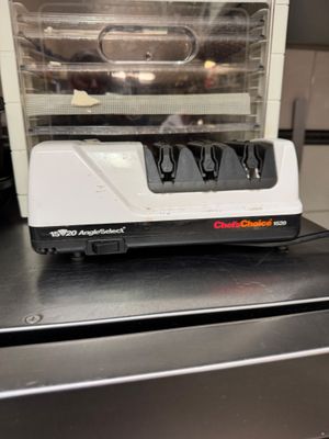 a white and black electric knife sharper on top of a counter
