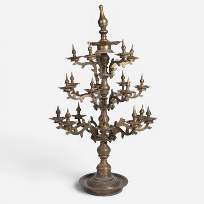 a large brass candelabra with birds on it