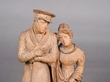 a statue of a man and a woman standing next to each other