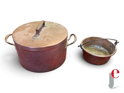 a pot and a bowl of soup on a white surface