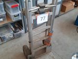 a hand truck with a sign on it in a garage