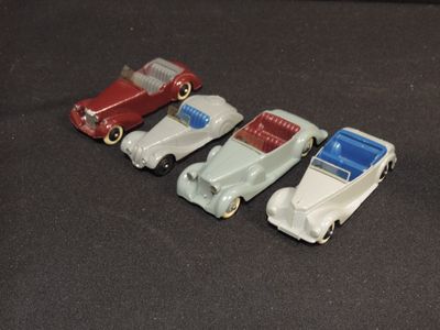 several toy cars are lined up in a row on a black surface
