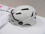 a white helmet sitting on top of a table next to a t - shirt