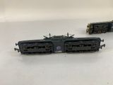 two toy trains sitting on top of a white table next to each other