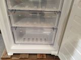 a small refrigerator with its door open on a pallet