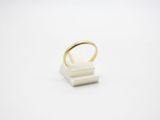 a white ring sitting on top of a wooden block