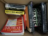 many books in a box that are sitting on top of each other