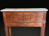 a wooden chest of drawers with marble top on a black background