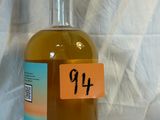 a bottle of alcohol sitting on a table with a price tag on it