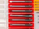 a lot of screws and screwdrivers in a plastic case