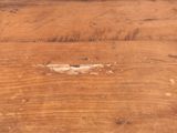a piece of wood that has been scratched off and is sitting on a table