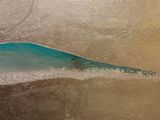 a surfboard that is sitting in the sand