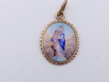 a picture of a picture of jesus and mary on a gold plated pendant