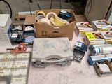 a lot of tape, scissors, tape and other items on the table