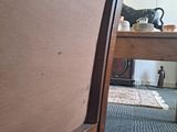 a cat that is sitting on the floor next to a table