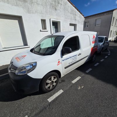 a white van parked in front of a white building