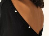a woman that is wearing a black shirt and a ring