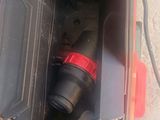 a black and red drill in a tool box