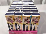 six boxes of toothpaste sitting on top of a white table
