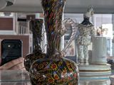 many different vases on the glass shelves in the store