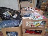 several boxes of clothes are stacked on top of each other in a room