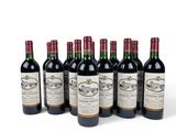six bottles of wine are lined up in a row on a white surface