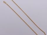 a gold chain on a white background