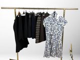 a clothes rack with clothes hanging on it and a guitar