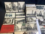 a lot of old postcards on display on a table