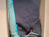 a cardboard box with a bunch of clothes inside of it