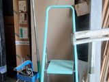 an image of a room with a ladder, chair and a fan