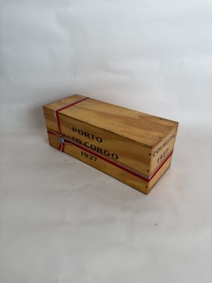 a small wooden box with a red ribbon on it