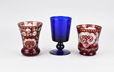 three glass vases sitting next to each other on a table